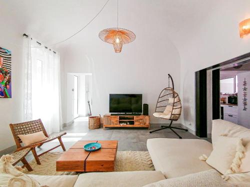 a living room with a couch and a tv at Layla Luxury Home in Santa Teresa Gallura