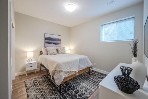 a bedroom with a bed and a window at Evergreen Condo by Leavetown Vacations in Penticton