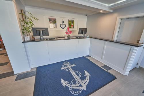 an empty waiting room with an anchor painted on the floor at Hyannis Plaza Hotel in Hyannis