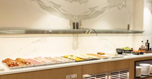 a buffet line with many different types of food at Ilunion Barcelona in Barcelona