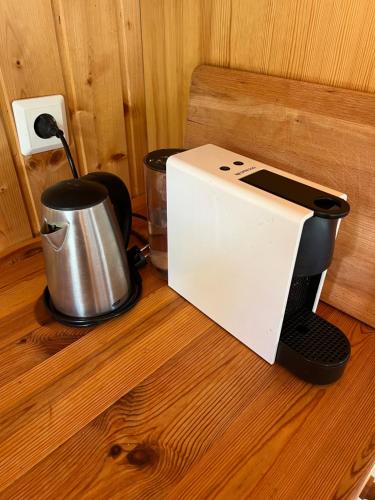 a toaster and a coffee maker on a wooden table at Summerhouse Vaglaskogur in Akureyri