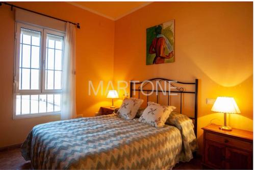a bedroom with a bed and two lamps and a window at Casa Vacacional Vigo Planta Baja in Vigo