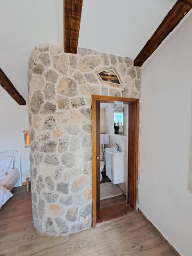 a room with a stone wall and a doorway at Danino in Jezera