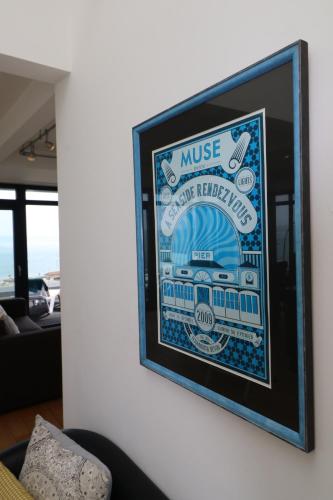 a framed picture of a train on a wall at Riviera Apartments - Five Stylish Penthouse Apartments with Unrivalled Sea Views of Teignmouth, Shaldon, The Jurassic Coastline & The Teign Estuary in Teignmouth