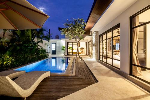 a swimming pool in the backyard of a house at Billi Bali Villa in Canggu