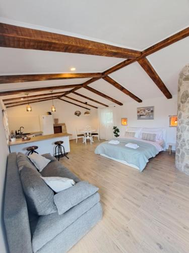 a living room with a couch and a bed at Danino in Jezera