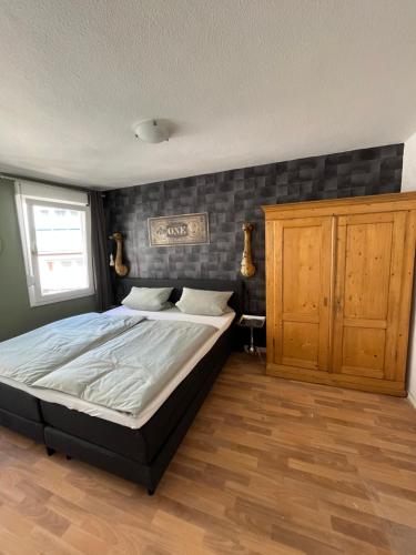 a bedroom with a large bed and a wooden floor at Meyver Cochem Centrum. in Cochem