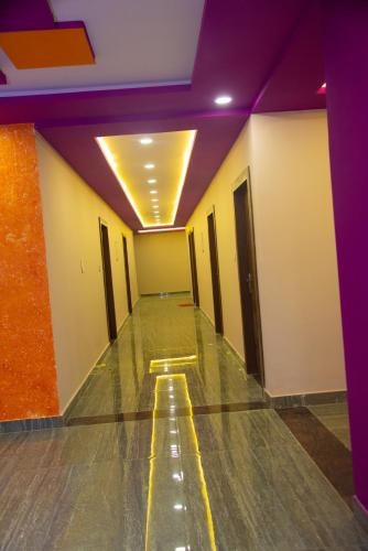 an empty hallway with purple lights and a bowling alley at The Nirvana Resort in Chatra