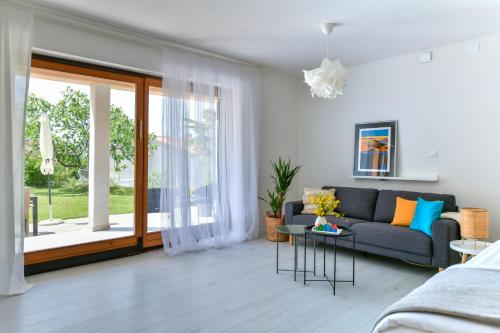 a living room with a couch and a large window at Apartment Alex in Labin