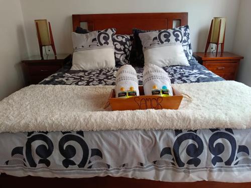 a bed with two pairs of socks on it at Samor centro histórico Bogota in Bogotá