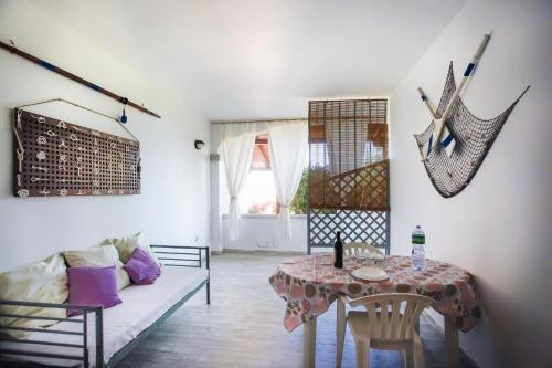 a living room with a table and a couch at Bilo Mare 2 in Budoni