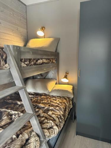 a bedroom with two bunk beds with a ladder at Röstbergsgårdarna in Funäsdalen