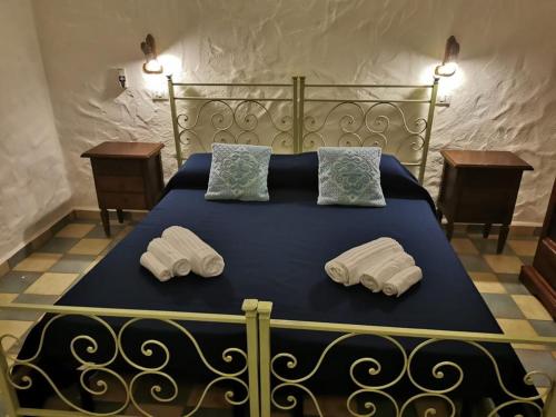 a bedroom with a bed with two pillows on it at Is Bisus in Castiadas