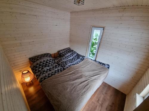 史澈契內克的住宿－Leśna Przystań，一个小房间的一个床位,设有窗户