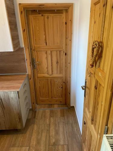 a wooden door in a room with a wooden floor at Apartmány na Vršku in Plzeň