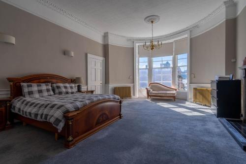 a bedroom with a bed and a tv and a window at Luxury Apartment/Flat Edinburgh City Centre in Edinburgh