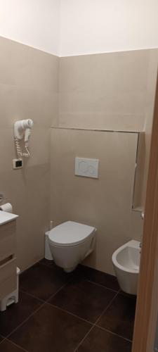 a white bathroom with a toilet and a sink at Agriturismo il Tuccanese di Russo Gerardo in Bagnoli Irpino