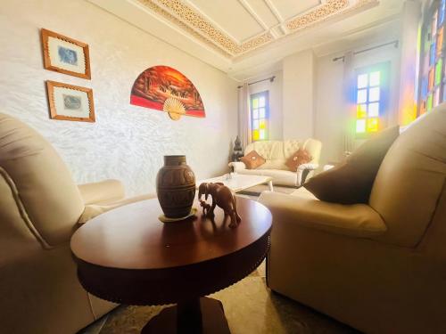 a living room with a couch and a table at Unique Villa Castle With Pool in Essaouira