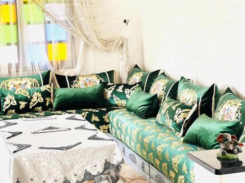 a living room with a green and white couch at Unique Villa Castle With Pool in Essaouira