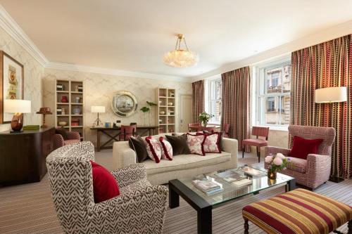 a living room with a couch and chairs and a table at Brown's Hotel, a Rocco Forte Hotel in London