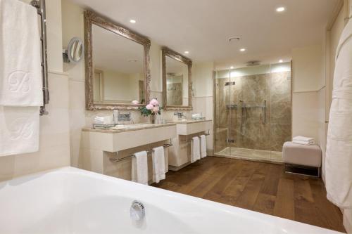 a bathroom with a tub and a sink and a shower at Brown's Hotel, a Rocco Forte Hotel in London