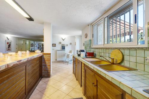 a kitchen with a sink and a counter top at Villa Gloria Guest House in Tovo San Giacomo