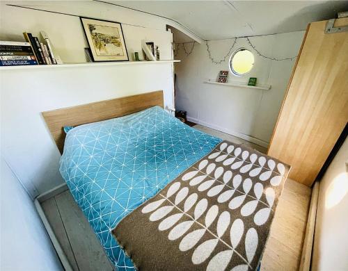 a small bedroom with a bed in a small room at Boutique Boat Stays Contemporary Barge in Bath