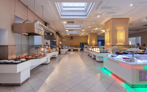 a restaurant with a buffet line of food at Djerba Holiday Beach in Midoun