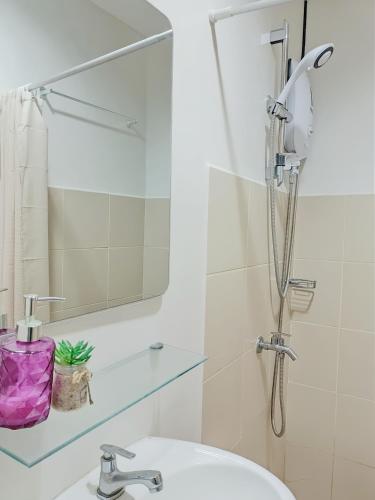 a bathroom with a shower and a sink at 11F Condo at The Loop Tower Limketkai Center CDO in Cagayan de Oro