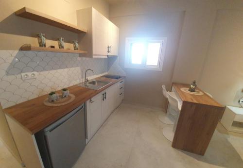 a small kitchen with a sink and a toilet at Stavroula Studios in Paleokastritsa