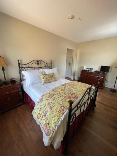 a bedroom with a large bed with a floral bedspread at The Union Hotel in Everett