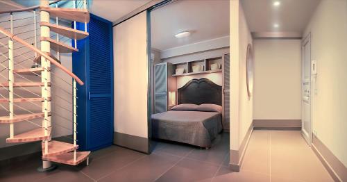 a bedroom with a bed and a staircase in a room at Cala del Porto Residence in Marettimo