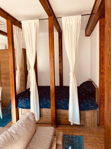 a living room with two bunk beds with curtains at Studio Mirage@Snow Residence (ski & forest) in Azuga