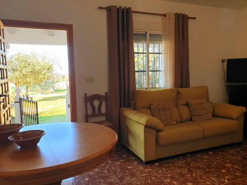 a living room with a couch and a table at La Caseja Rural in Ossa de Montiel