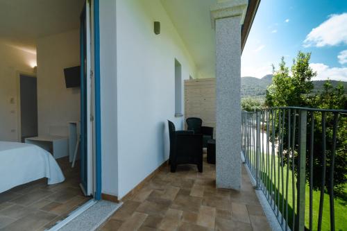 a room with a balcony with a bed and a view at Borgo Albador Rooms in Posada