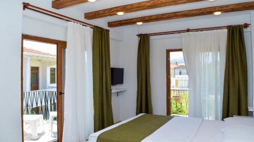 ein Schlafzimmer mit Bett und Balkon in der Unterkunft Gökçeada Deep Breath in Canakkale