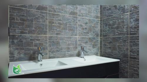 a bathroom with a sink and a brick wall at Cabaña Turistica Tunwacogua in Nobsa