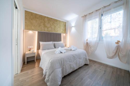 een slaapkamer met een bed met twee handdoeken erop bij B&B Infinito in Castelnuovo Rangone