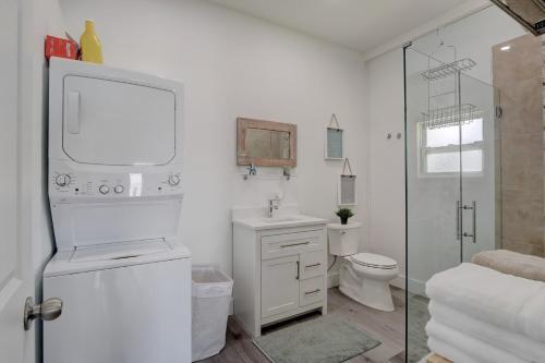 a white bathroom with a toilet and a shower at Guest House In a Downtown Bonita Springs Compound in Bonita Springs