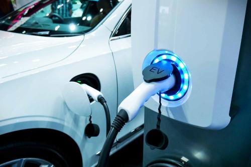 a white car is plugged into a electric car at LOGIS Hôtel de Bourgogne - Mâcon in Mâcon