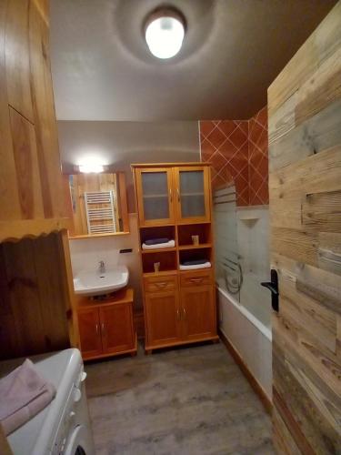 a bathroom with a sink and a bath tub at Chalet Campanule in Bonneval-sur-Arc