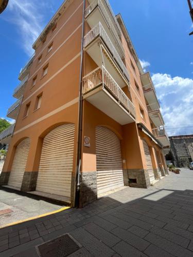 a building with two garage doors and a balcony at Moneglia Beach Downtown in Moneglia