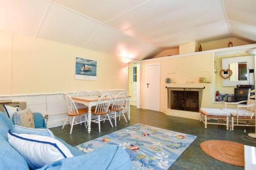 a living room with a couch and a table at Family Compound walk to Downtown! in Wellfleet