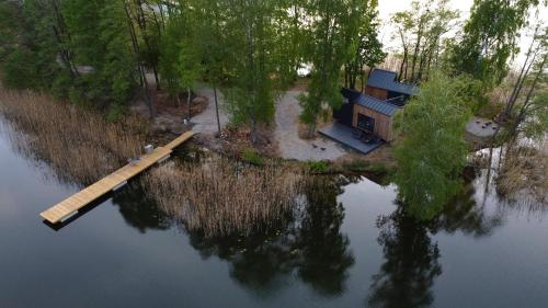 an aerial view of a house in the middle of a lake at Tiny House - Osada Wilkasy in Giżycko