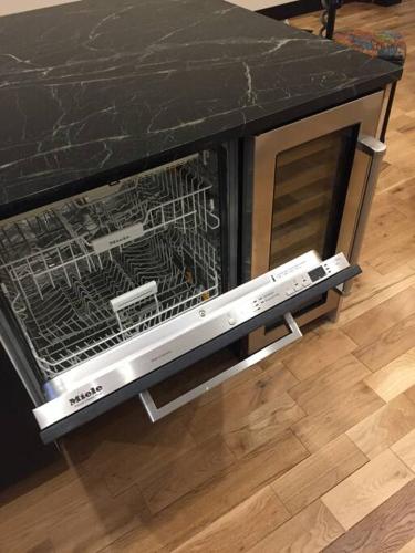 a dishwasher with its door open on a counter at Elegant Townhouse, Hudson center, 3 ensuite baths in Hudson