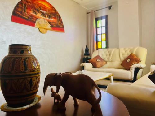 a toy dog and a vase on a table in a living room at Unique Villa Castle With Pool in Essaouira