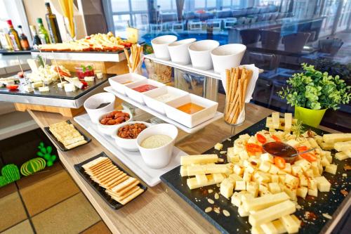 a buffet with several different types of cheese and appetizers at LABRANDA Bahía Fañabé & Villas in Adeje