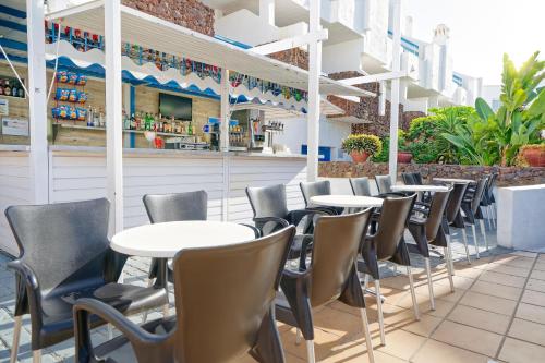 a row of tables and chairs at a restaurant at LABRANDA Bahía Fañabé & Villas in Adeje