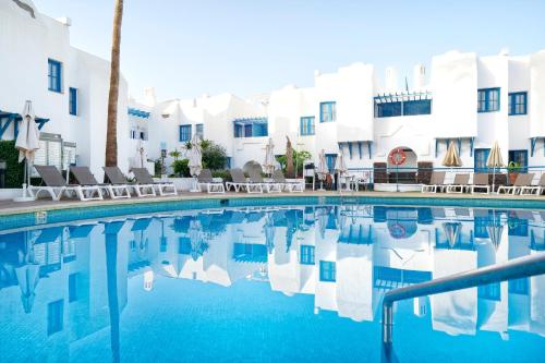 a swimming pool in front of a hotel at LABRANDA Bahía Fañabé & Villas in Adeje