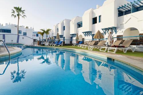 a swimming pool in front of a resort at LABRANDA Bahía Fañabé & Villas in Adeje